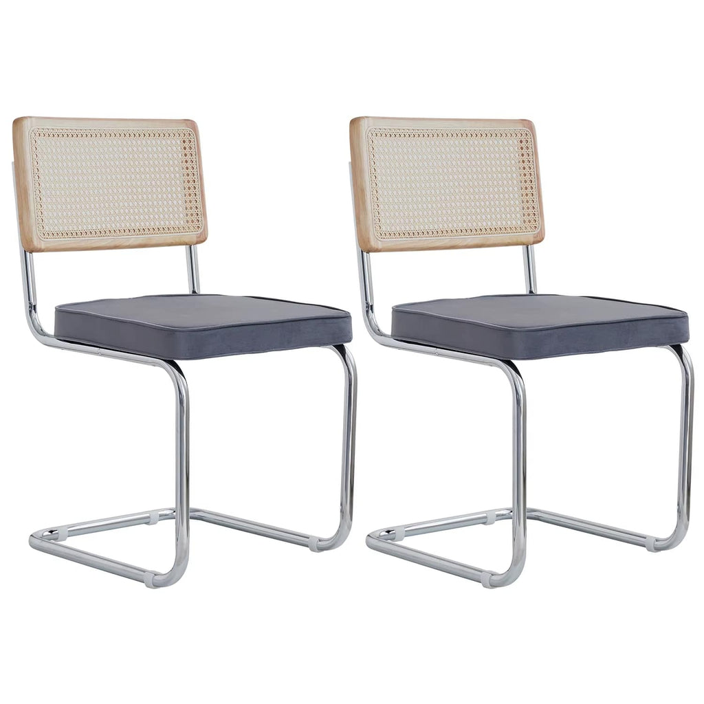 Two modern dining chairs with hand woven wicker, metal legs and padded seats