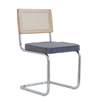 Two modern dining chairs with hand woven wicker, metal legs and padded seats