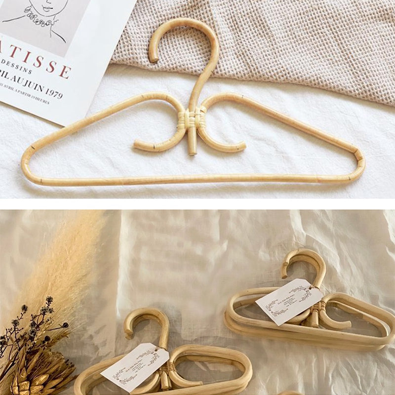 Two hand woven rattan clothes hangers with gold metal hooks and inner hooks