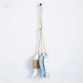Three painted wood fish hanging together on a twine cord