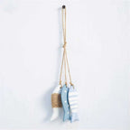 Three painted wood fish hanging together on a twine cord