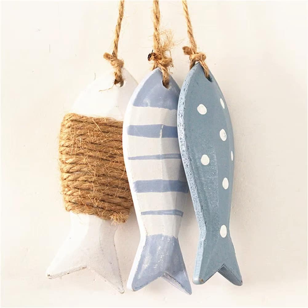 Three painted wood fish hanging together on a twine cord