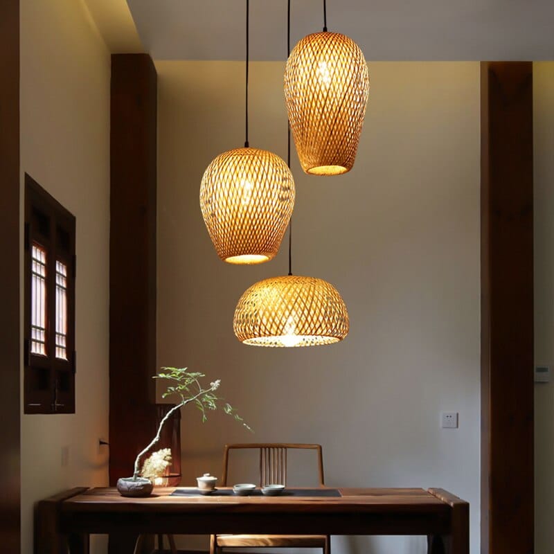 Three woven rattan pendants of different shapes hung as a cluster