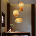 Three woven rattan pendants of different shapes hung as a cluster