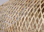 Three woven rattan pendants of different shapes hung as a cluster
