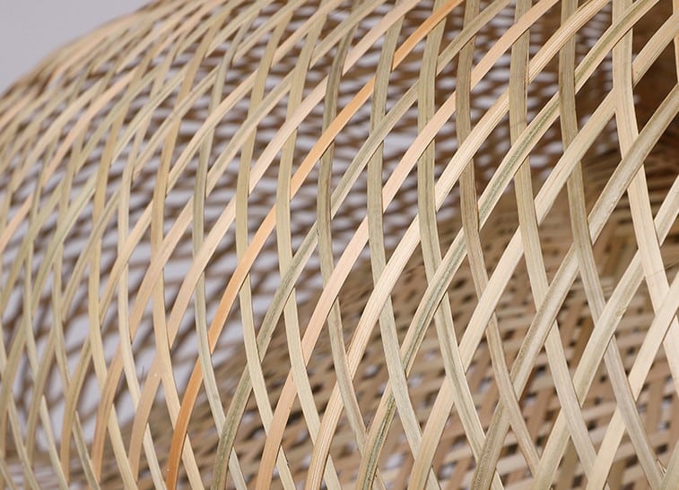 Three woven rattan pendants of different shapes hung as a cluster