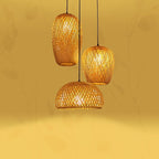 Three woven rattan pendants of different shapes hung as a cluster