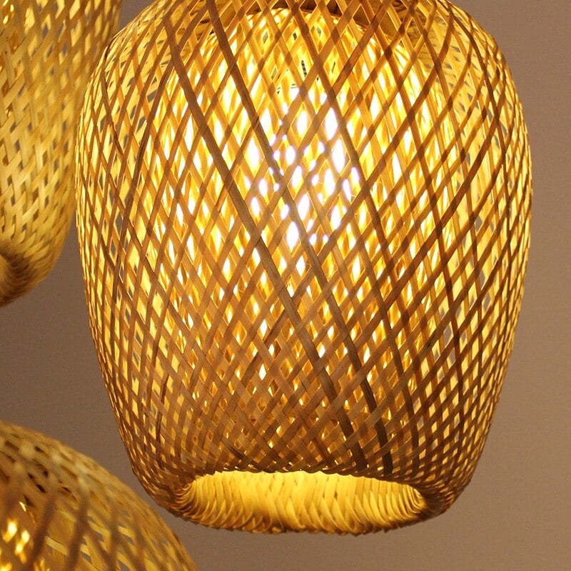 Three woven rattan pendants of different shapes hung as a cluster