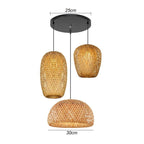 Three woven rattan pendants of different shapes hung as a cluster