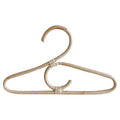 Kids' clothes hanger hand woven in natural rattan in a simple shape