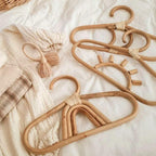 Kids' clothes hanger hand woven in natural rattan in a fancy shape