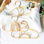 Kids' clothes hanger hand woven in natural rattan in a fancy shape