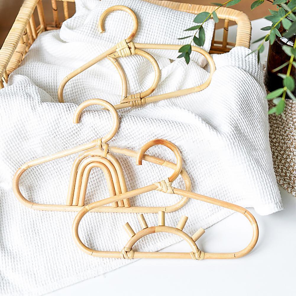 Kids' clothes hanger hand woven in natural rattan in a fancy shape