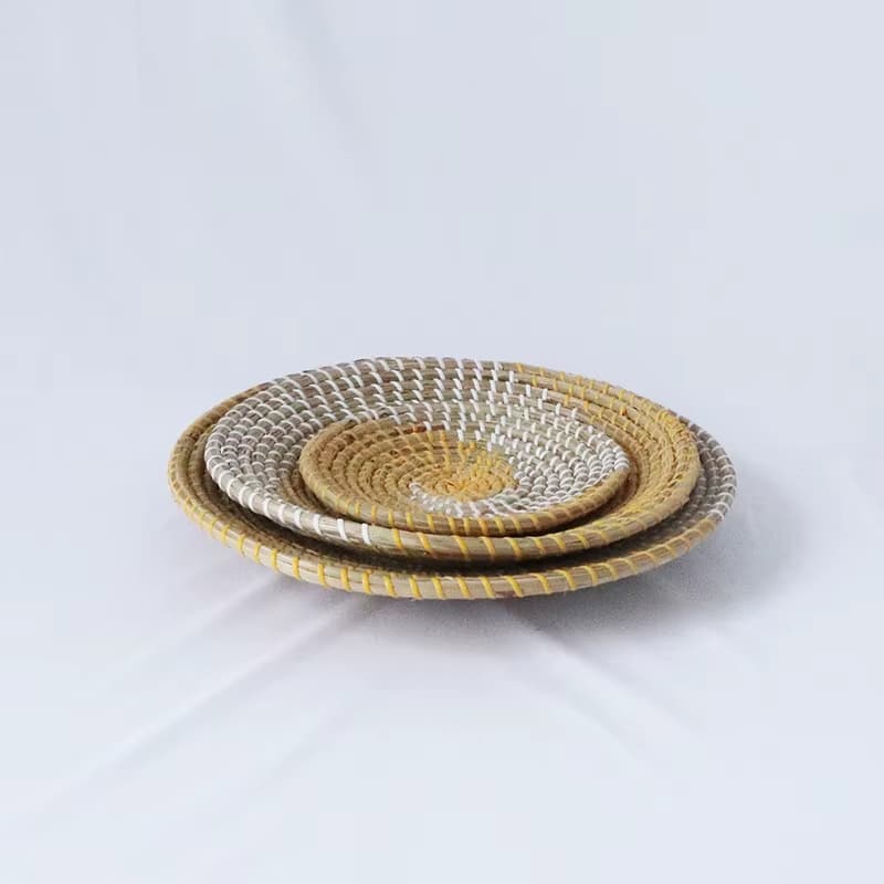 Three round woven wall baskets in natural and yellow tones