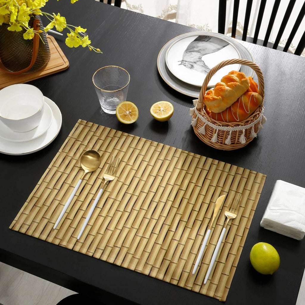 Four beige placemats with a woven bamboo look and interlaced patterns