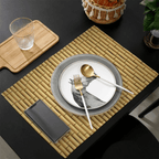 Four beige placemats with a woven bamboo look and interlaced patterns