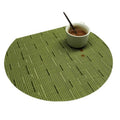 Four semi round green woven bamboo placemats