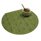 Four semi round green woven bamboo placemats