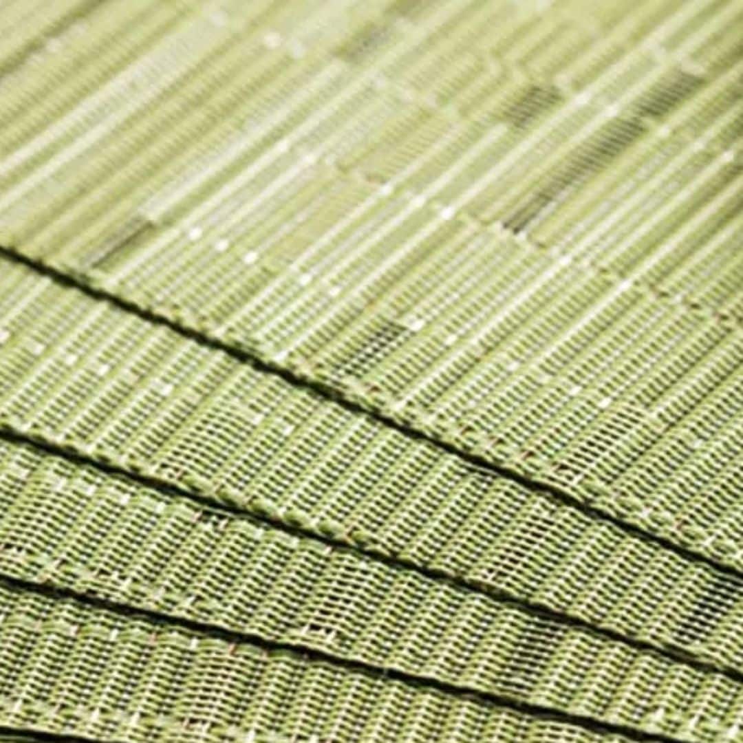 Four semi round green woven bamboo placemats
