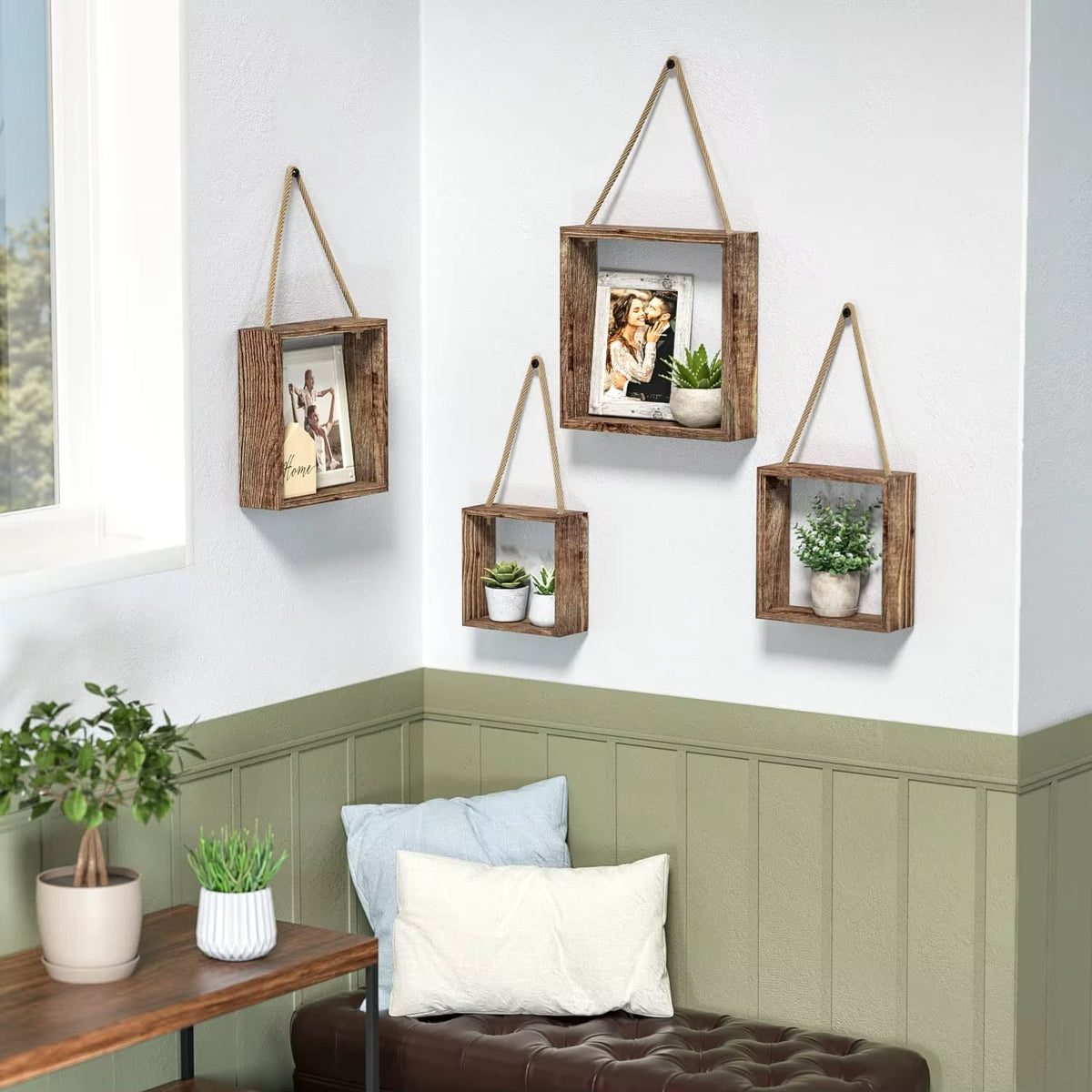 Four square wood box shelves hanging on rope with plants and a photo