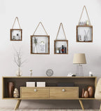 Four square wood box shelves hanging on rope with plants and a photo