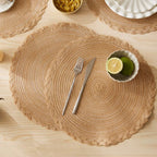 Four round Japanese style placemats with a regular woven straw look