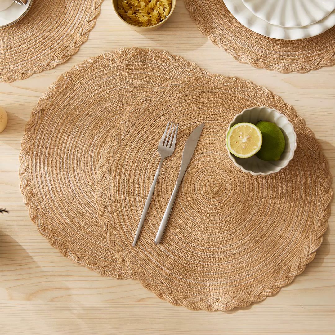 Four round Japanese style placemats with a regular woven straw look