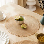 Four round Japanese style placemats with a regular woven straw look