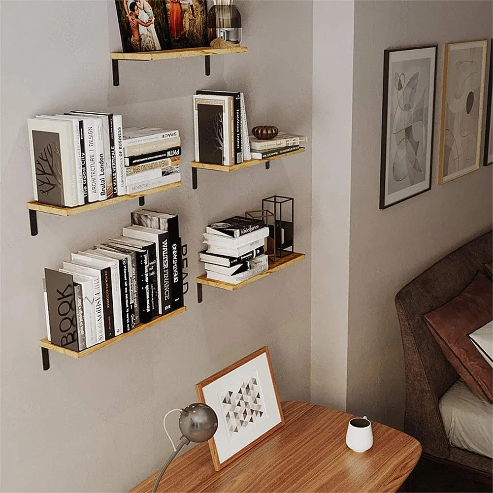 Set of four light wood floating shelves arranged on a wall