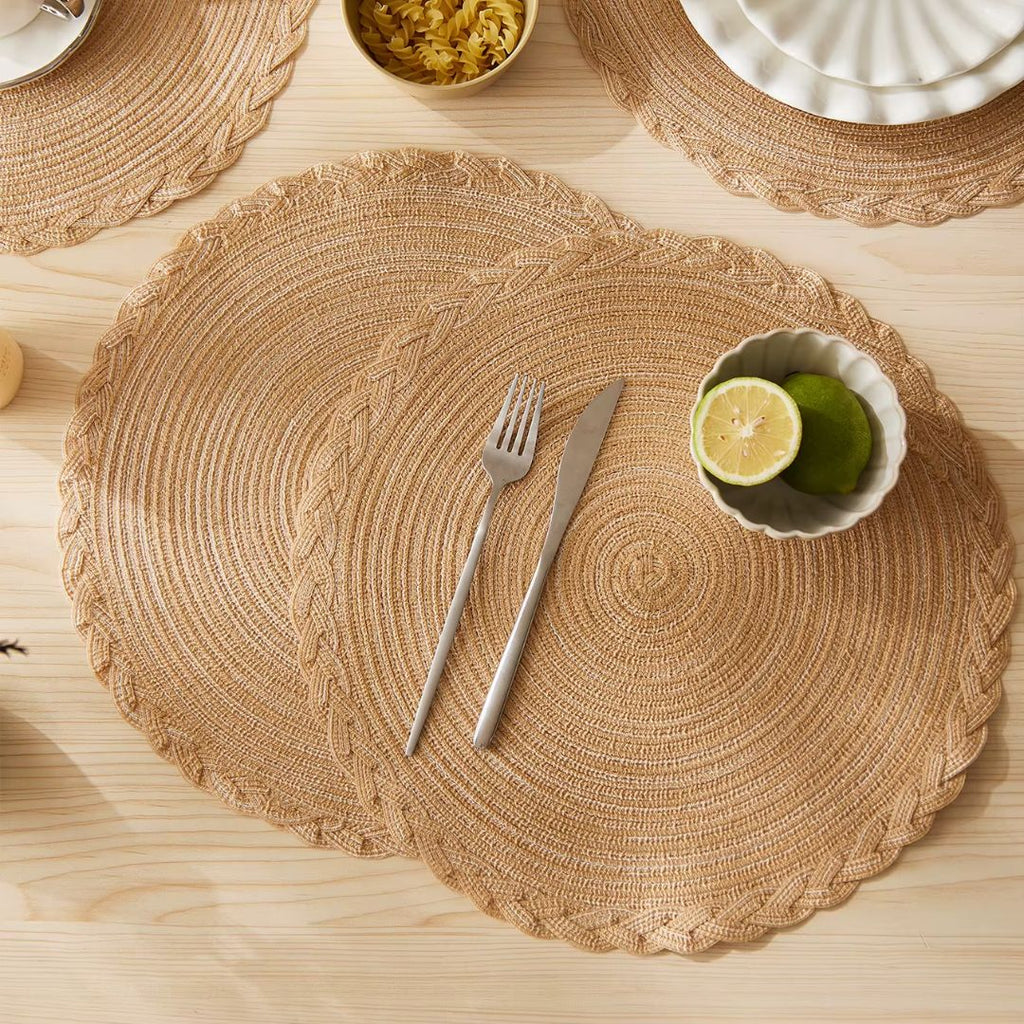 Four round beige placemats with a tight spiral straw look weave