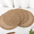 Four round woven linen placemats with a wavy edge in warm brown