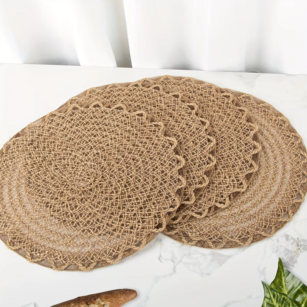 Four round woven linen placemats with a wavy edge in warm brown