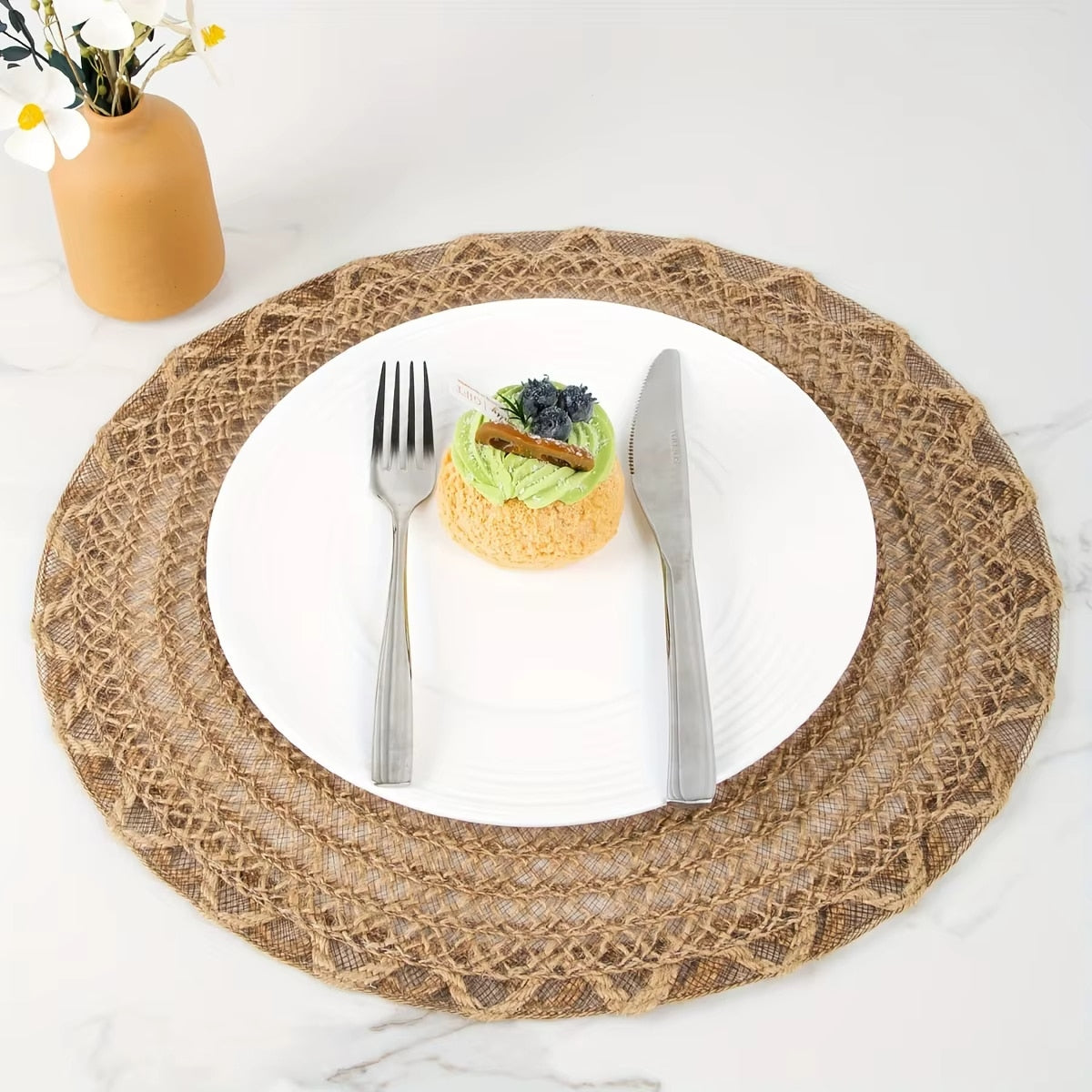 Four round woven linen placemats with a wavy edge in warm brown