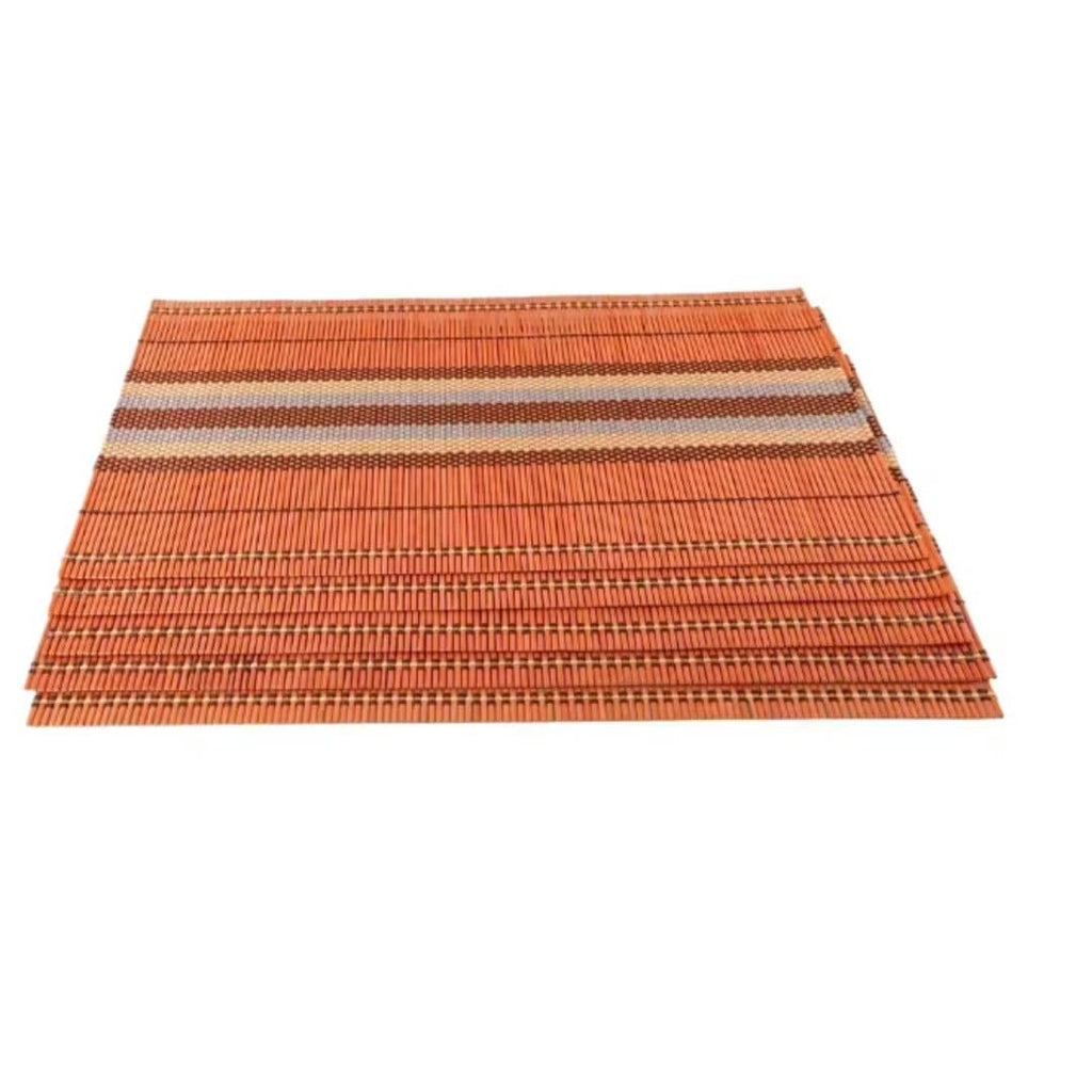 Five boho woven bamboo placemats in a warm orange tone