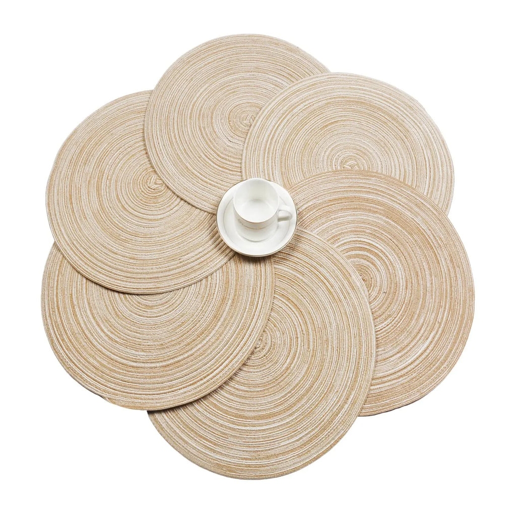 Six round beige coasters with a woven rattan look