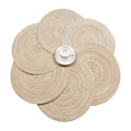 Six round beige coasters with a woven rattan look
