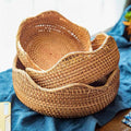 Shallow round honey rattan baskets with wavy rims