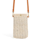 Small rounded beige hand woven rattan crossbody bag with a button closure