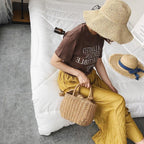 Small structured hand woven rattan handbag with warm natural highlights