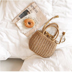 Small structured hand woven rattan handbag with warm natural highlights