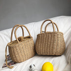 Small structured hand woven rattan handbag with warm natural highlights