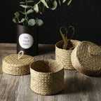 Small round woven straw basket with lid holding cosmetics