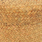 Small round woven straw basket with lid holding cosmetics