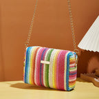 Small woven straw handbag with bright multicolor bands