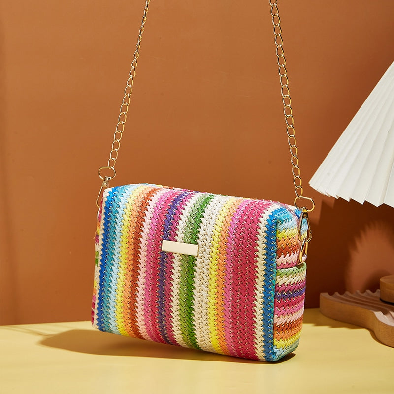Small woven straw handbag with bright multicolor bands