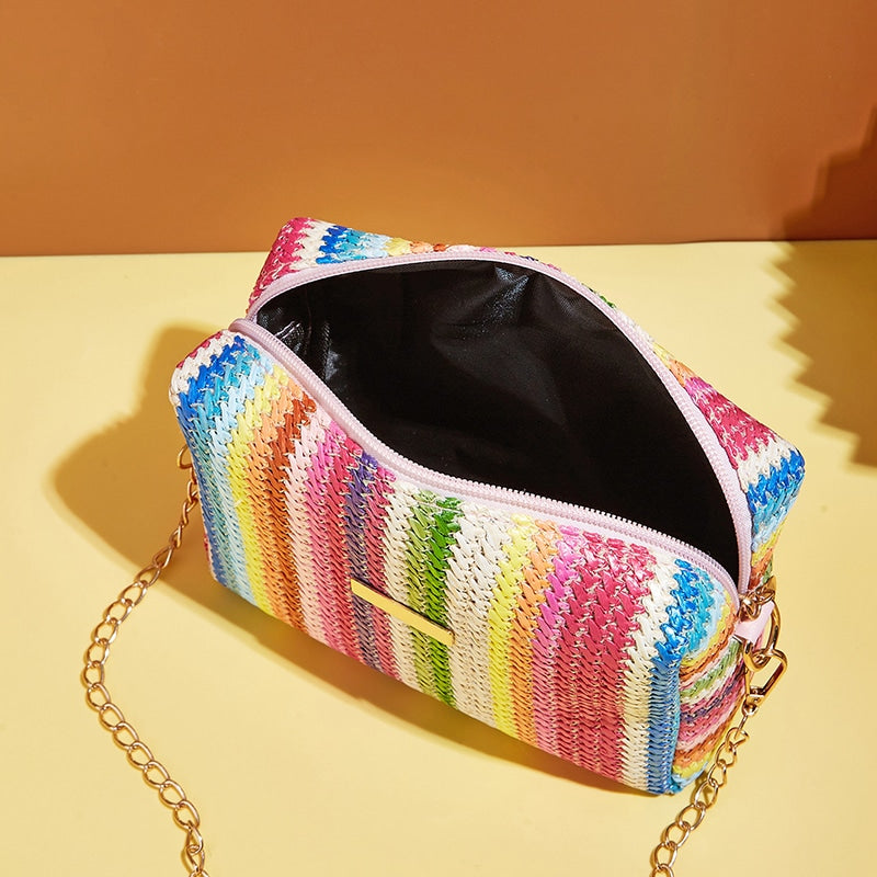 Small woven straw handbag with bright multicolor bands