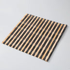 Small rectangular hand woven bamboo placemat in beige and black tones