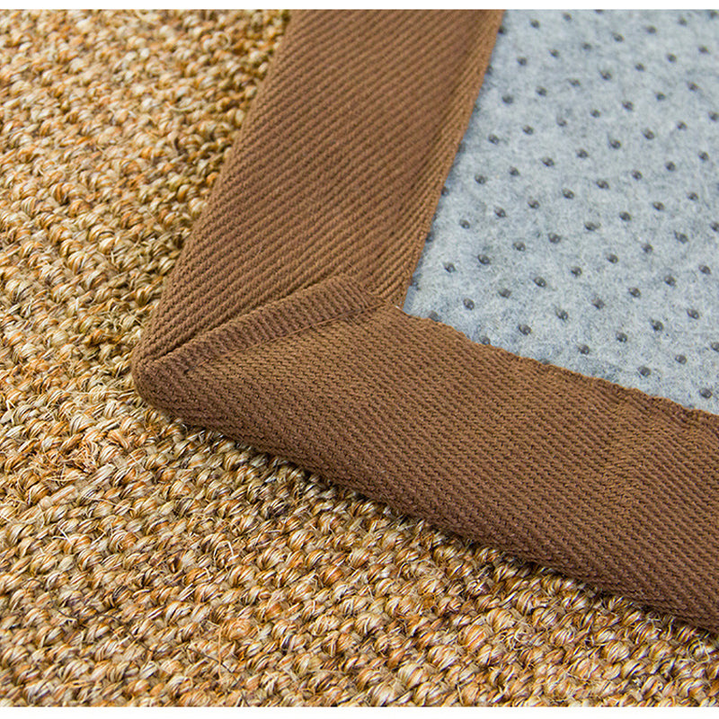 Small beige flatweave rug with a brown fabric border