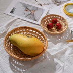 Small round open weave rattan bowls on a table