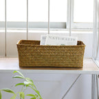 Small narrow rectangular woven baskets holding napkins and jars